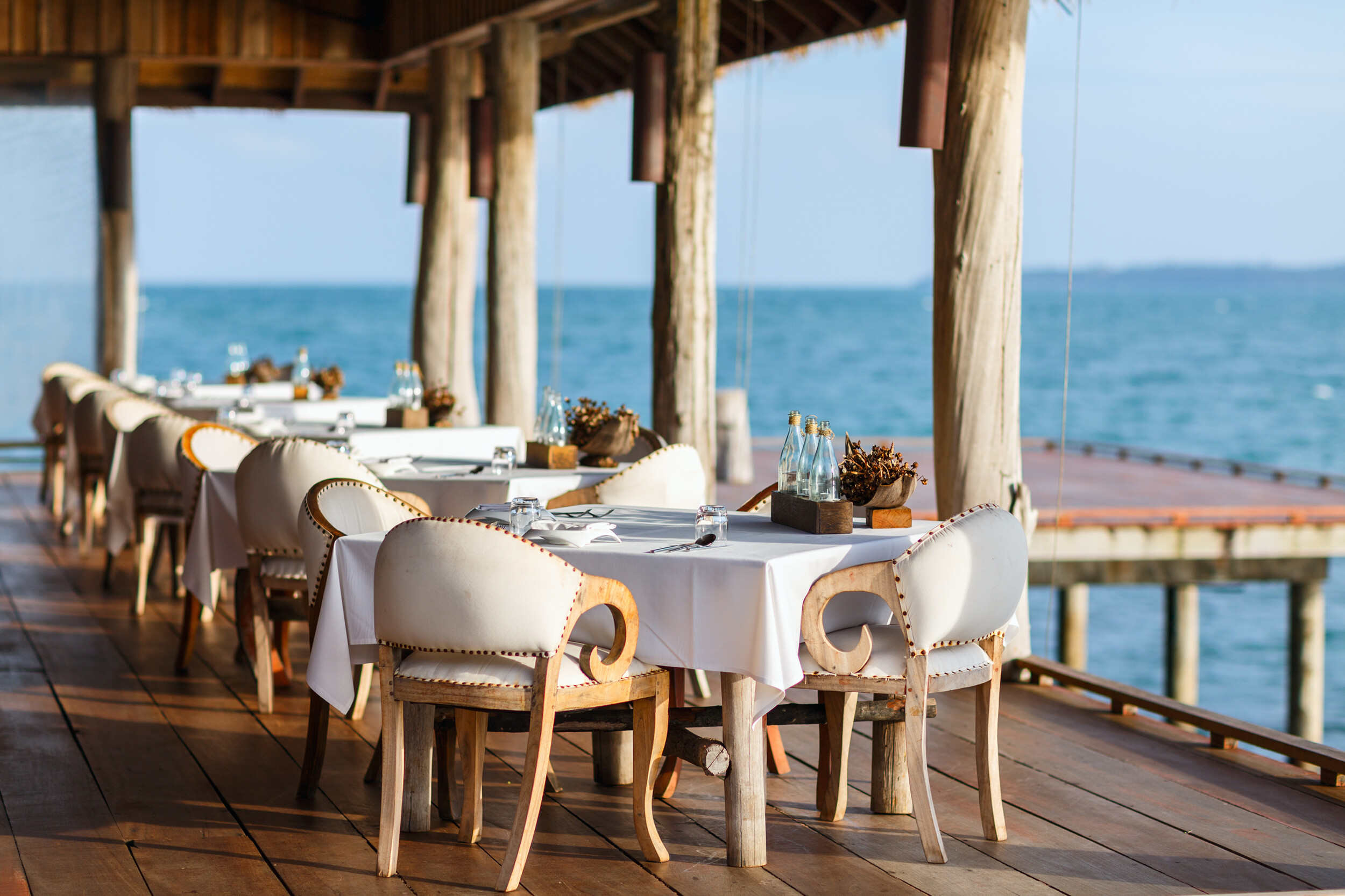 song-saa-private-island-vista-over-water-restaurant-interior-side-shot-seating-deck-family-photos-20178